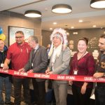Long Plain First Nation members cutting a ribbon to open a hotel