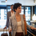 A couple arriving at a hotel smiling