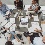 Business people in discussion sitting around a conference table