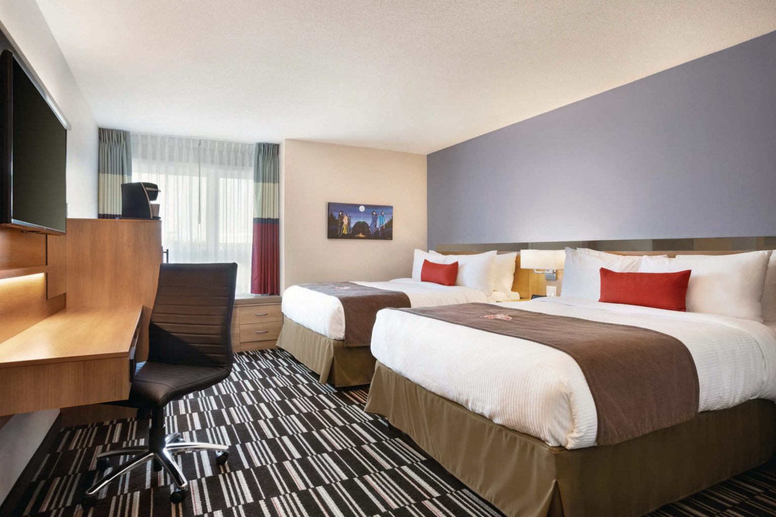 A hotel room with two queen beds