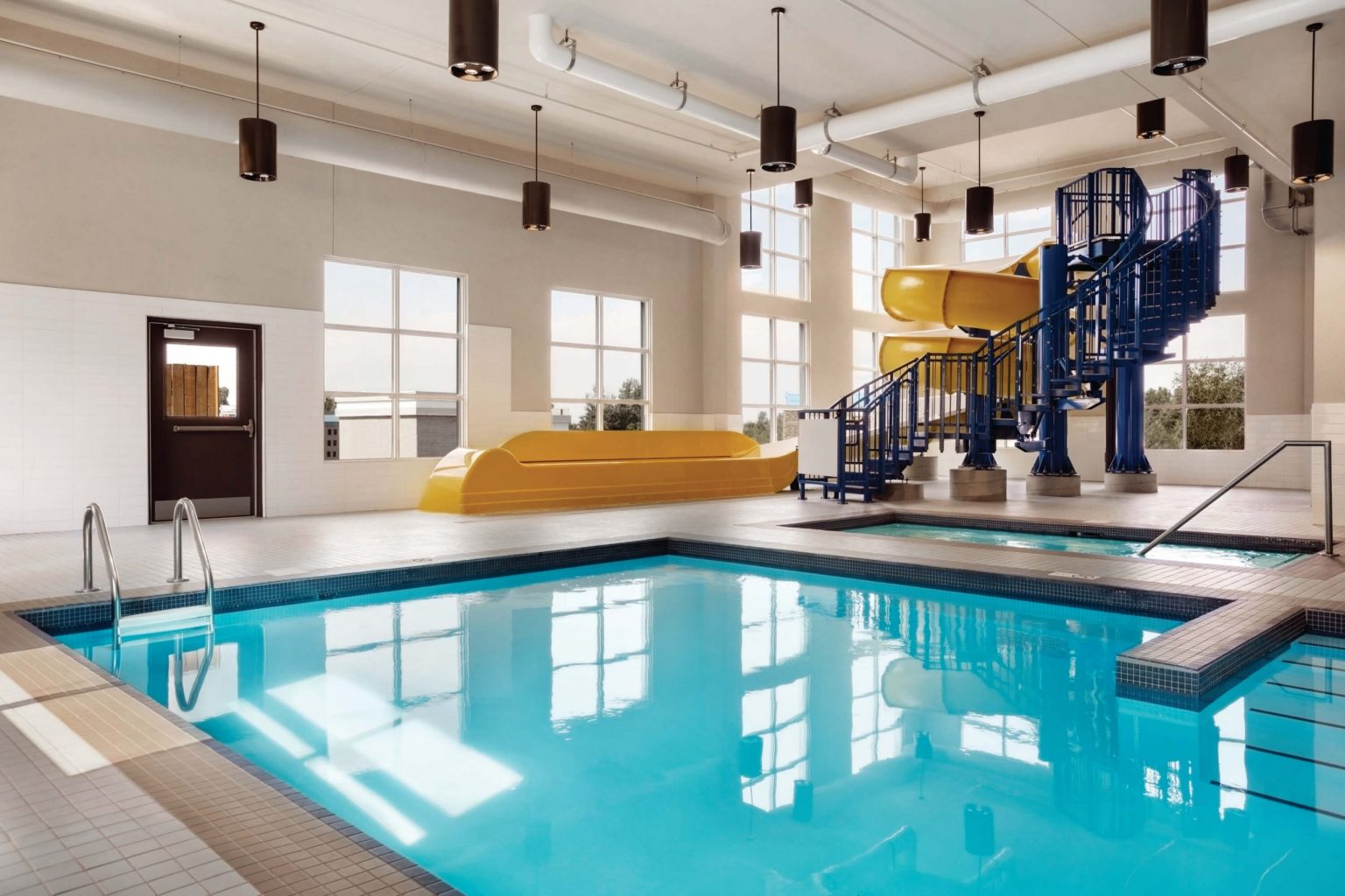 An indoor pool with a large waterslide